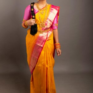 Elegant portrait of a South Indian woman wearing a traditional saree with jewelry, highlighting cultural beauty.